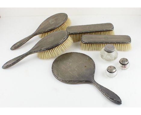 A silver mounted five piece dressing set, by William Neale &amp; Son Ltd, assayed Birmingham 1913-16, comprising a hand mirro