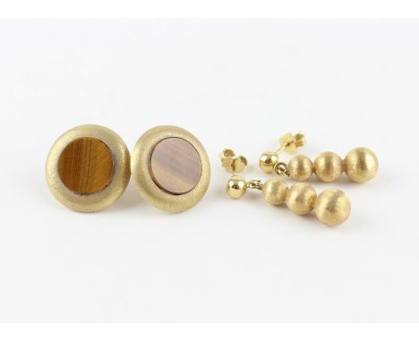A pair of 18ct. gold drop earrings, having polished gold spere suspending three graduated and textured spheres, post and butt