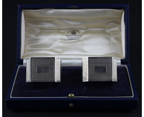 A pair of silver napkins, by Mappin &amp; Webb Ltd, assayed Birmingham 1939, of square form with chamfered corners, all over 