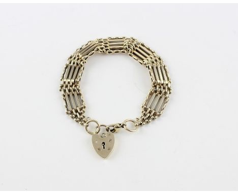 A 9ct. yellow gold five bar gate bracelet, with lobster claw and heart padlock clasps, impressed "375", width 13mm, the heart