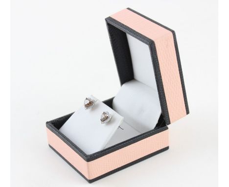 A pair of 18ct. white gold and diamond heart shape stud earrings, set cognac heart shape cut diamond surrounded border of rou