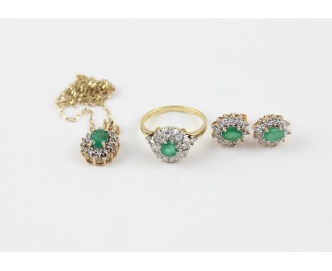 An 18ct. gold, emerald and diamond cluster ring, the white gold mount set round cut emerald to centre surrounded border of ei