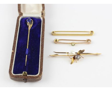 A 9ct. yellow gold, light blue stone and mother of pearl "bee" bar brooch, having engraved wing detail, set (aquamarine or to