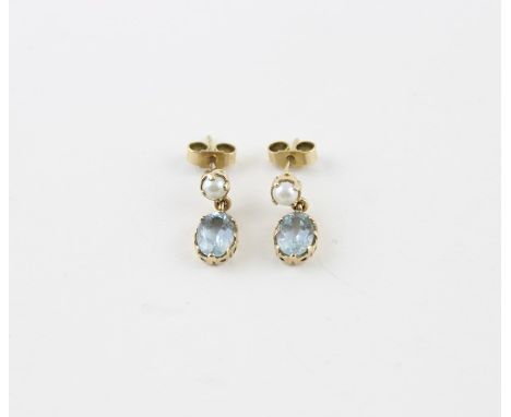 A pair of 9ct. gold, pearl and aquamarine drop earrings, each having claw set pearl suspending oval cut aquamarine drop, post