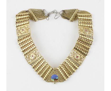 A yellow metal, enamel and ruby collar necklace, having central triangular pierced panel with multi-coloured enamelled disc a