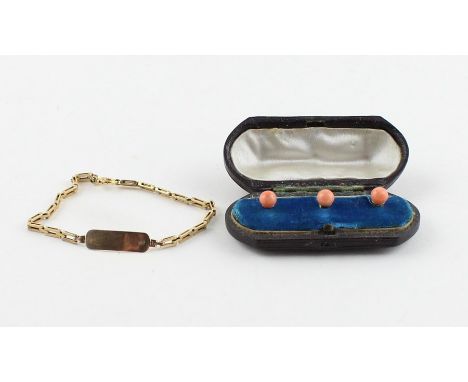A cased set of three yellow metal and pink coral shirt studs, each set spherical pink coral cabochon button with gently dishe