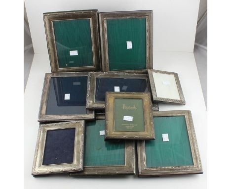 A collection of nine silver photograph frames, all of rectangular form with easel backs for portrait or landscape use, to inc