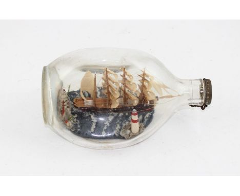 A Haig's Whisky ship in a bottle, in original dimple glass, 20 cm long, together with A WW2 Theodolite housed in original box