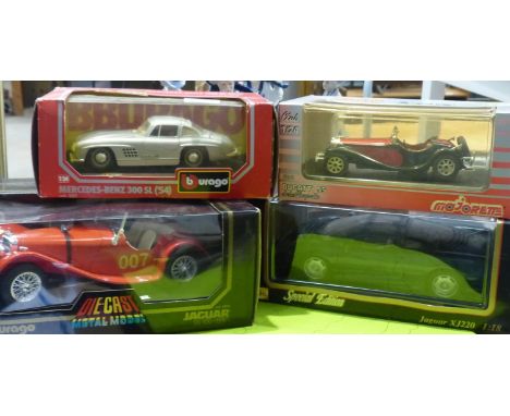 Four model cars to include Burago and Maisto, 1/18 and 1/24 scale. P&amp;P Group 3 (£25+VAT for the first lot and £5+VAT for 