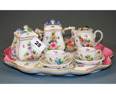 A 19th Century Continental porcelain three piece tea set, together with a pair of porcelain cups and saucers and tray, teapot