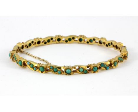 An antique yellow metal (tested 18ct gold) turquoise set bangle, L. 5.5cm.