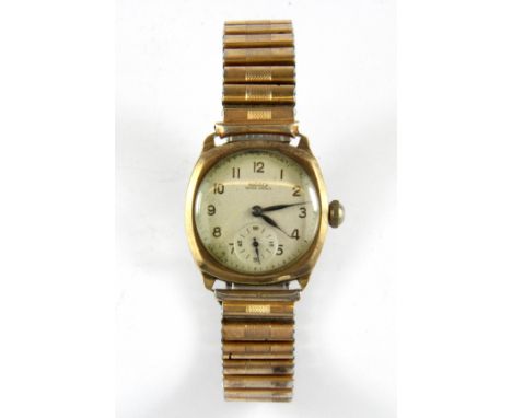 A gent's vintage 9ct gold Rotary wristwatch on a expanding gold plated strap (W/O but not fully tested).