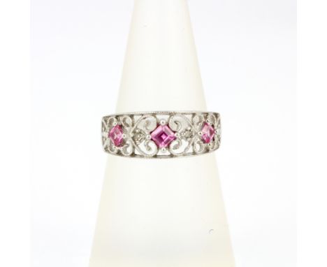 A 9ct white gold ring set with pink sapphires and diamonds, (M.5).