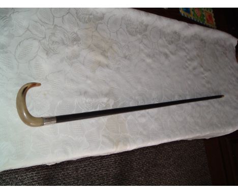 This is a nice horn handled cane with a silver collar hallmarked for London 1923 together with the makes mark too faint to re