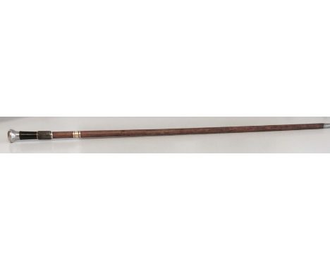 An attractive Victorian cane with a concealed telescope. This cane is capped with a silver knob. The handle is brass, black e