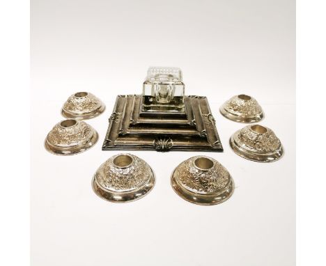 A silver plated inkwell with six plated candlesticks.