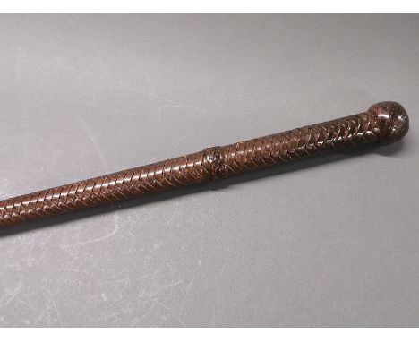 An early 20th century Indian army officer's walking/swagger stick covered with plaited leather, L. 87cm.