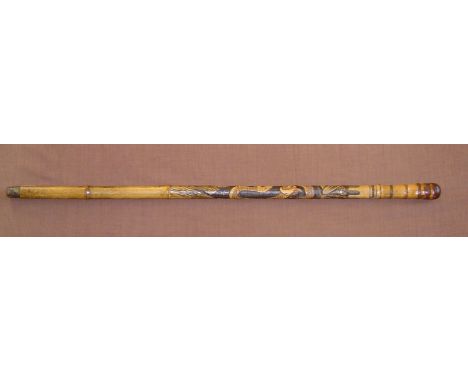 A heavy bamboo walking stick carved with an elaborate oriental design of an eagle and large snake in combat. Join between bla