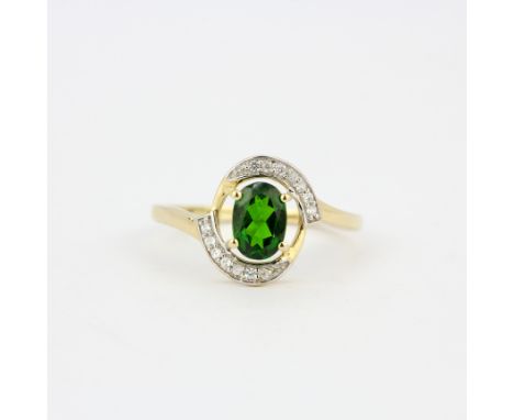 A 9ct yellow gold ring set with an oval cut chome diopside and diamonds, (O).