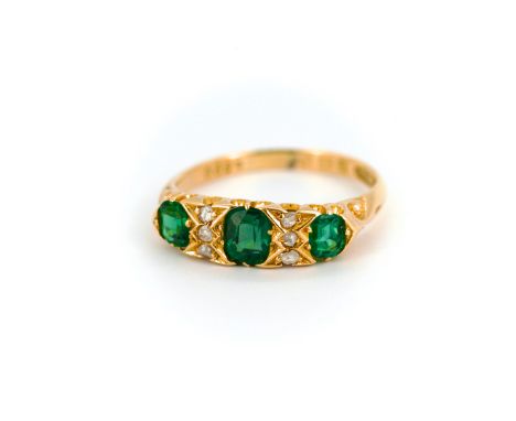 A 19th century style 18ct yellow gold ring set with small brilliant cut diamonds and three sythentic emeralds, Chester hallma