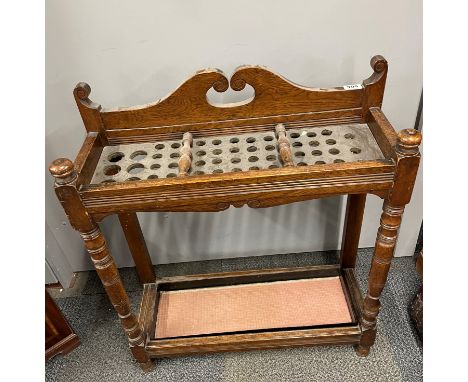 Two early 20th century oak walking stick stands, each with inset stick separators. Largest 80 x 25 x 83cm.