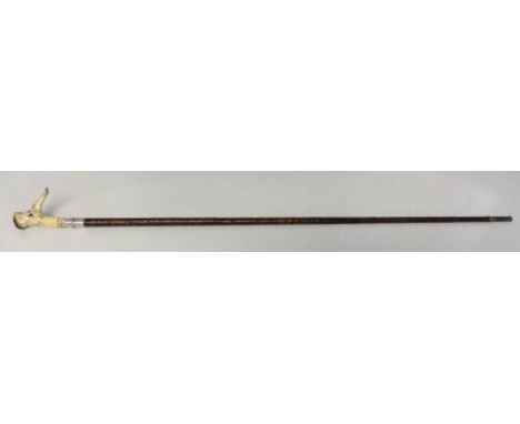 A very unusual stick indeed. The handle is a carved from an antler horn into the form of a rather ugly sitting man. He measur