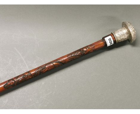 A Japanese carved bamboo sword stick with ornate silvered metal handle, L. 90cm.