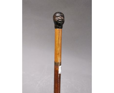 A 19th century sword stick with moulded phenolic negro head handle, L. 87cm.