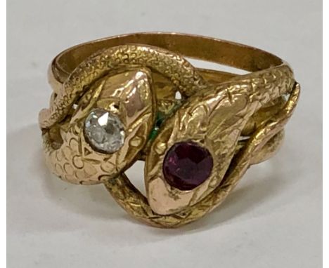 A Gift from ElvisAn attractive and unusual gold interwoven and shaped "Serpent" Ring, with diamond and garnet insets. Size R;