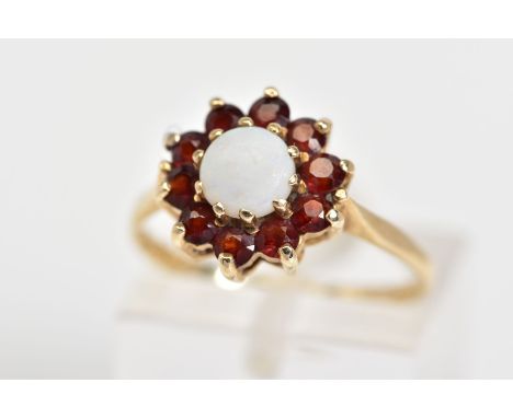 A 9CT GOLD CLUSTER RING, the tiered cluster set with a central opal with a circular cut garnet surround to the tapered should