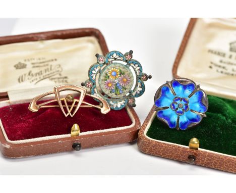 THREE BROOCHES, the first a silver Yorkshire rose design brooch set with blue enamel, with a Birmingham hallmark, an openwork