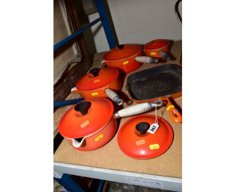 A SET OF FOUR GRADUATED LE CREUSET PANS AND COVERS (the smallest pan having chip to the cover and finial missing) with a matc