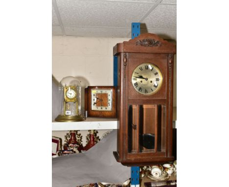 A BRASS SKELETON CLOCK UNDER A GLASS DOME, having enamelled dial with Arabic numerals, with an Art Deco wooden mantle clock, 