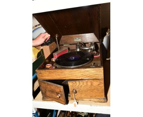 A DULCEOLA WIND UP TABLE TOP RECORD PLAYER with a box of 78's vinyl records