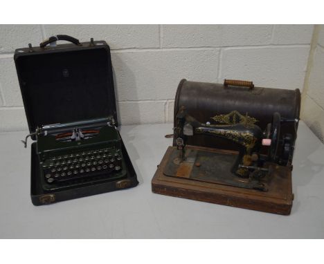 A VINTAGE CASED CORONA MODEL S GREEN ENAMEL TYPEWRITER, together with a distressed oak cased Singer sewing machine (2)