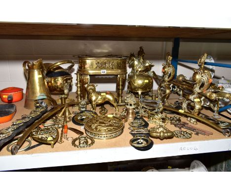 A GROUP OF BRASSWARE, to include a large brass trivet standing 30cm high, a fireside companion set, the fire dogs having grif