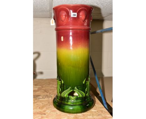 A BRETBY STICK STAND, having burgundy rim, fading to green pierced decoration around the base, standing height 63cm