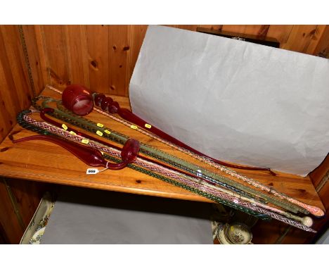 TWO VICTORIAN CRANBERRY GLASS PIPES, approximate lengths 43cm and 84cm, the largest formed of two separate sections, together