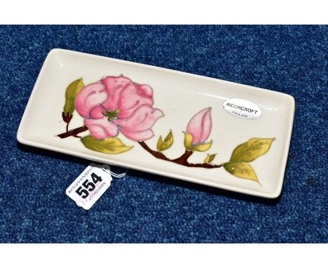 A MOORCROFT MAGNOLIA PATTERN RECTANGULAR TRINKET DISH, on cream ground, approximate length 20.5cm x width 9cm