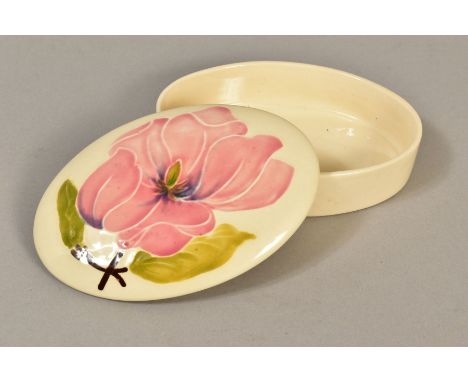 A MOORCROFT POTTERY TRINKET BOX AND COVER, 'Magnolia' pattern on cream ground, impressed backstamp, approximate length 12.5cm