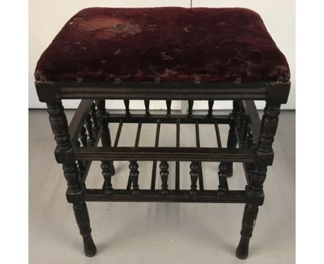A vintage dark wood framed piano stool with turned detail to legs and spindles. Galleried, spindled undershelf for music. Nee