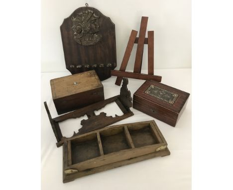 A collection of assorted misc. wooden items. Comprising: 2 lidded boxes, a book stand/easel, a wall hanging rack with centuri