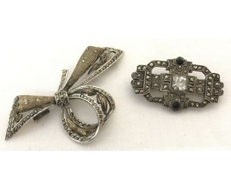 A vintage silver brooch in the shape of a decorative bow. Marked VA 925. Together with a white metal Art Deco style brooch se