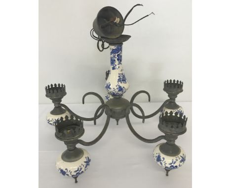 A 5 branch metal and ceramic ceiling hanging light. Central ceramic body and bulbous sections of each branch are decorated wi
