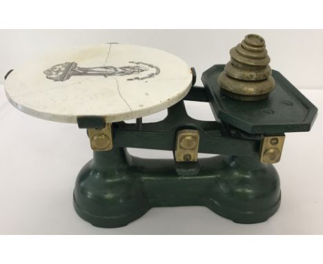 A set of vintage cast iron scales with ceramic plate and set of weights. A set of brass 1lb - ½oz weights. Ceramic plate depi