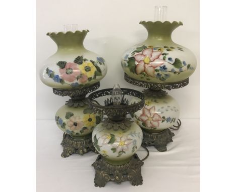 3 vintage glass and metal lamps with hand painted floral decoration, in the style of oil lamps. 2 complete with glass shades 