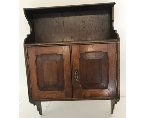 A small dark wood wall handing 2 door cupboard with shelf. Approx. 63 x 45cm.