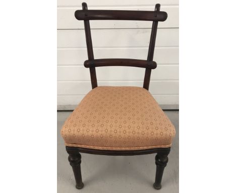 A vintage mahogany bedroom chair with turned detail to front legs and orange coloured upholstered seat. Approx. 78cm tall.