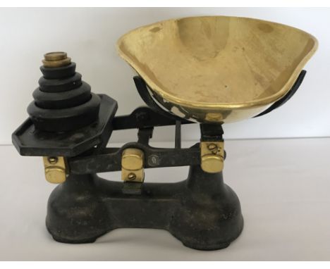 A set of vintage weighing scales complete with weights and brass scoop. E.R. and crown mark to body of scales.
