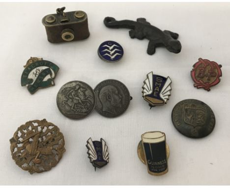 A small collection of vintage pin badges. Together with a Metropolitan Railway button, a miniature brass camera and a metal g